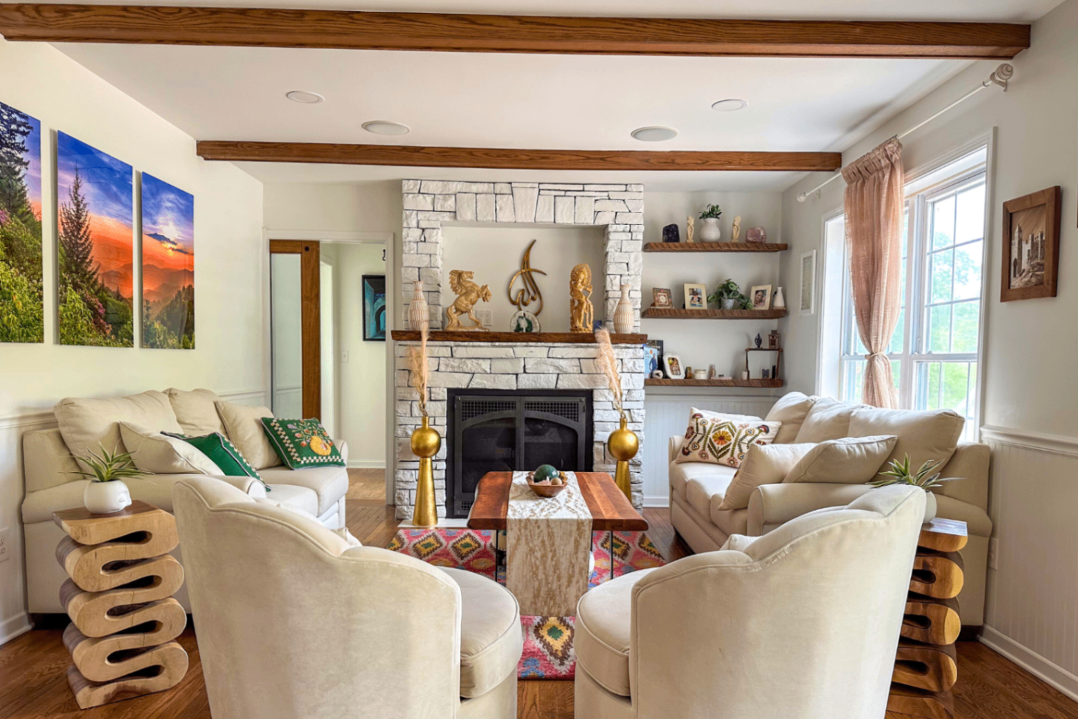 Living room with stone fireplace and beamed ceilings