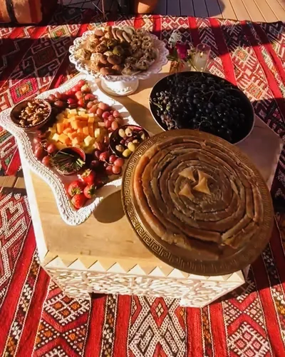 Moroccan sweets, fruit, olives, and pastries arranged on the grazing table