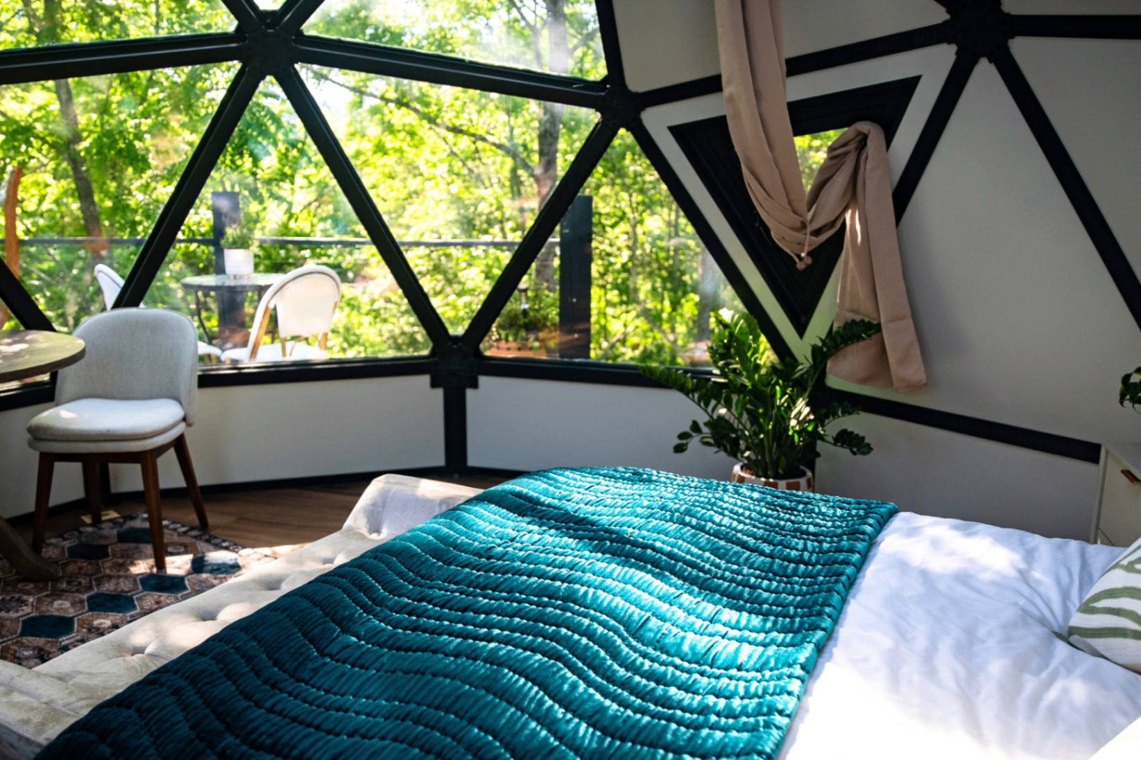 Fes dome — queen bed with carved Moroccan headboard and teal quilted throw