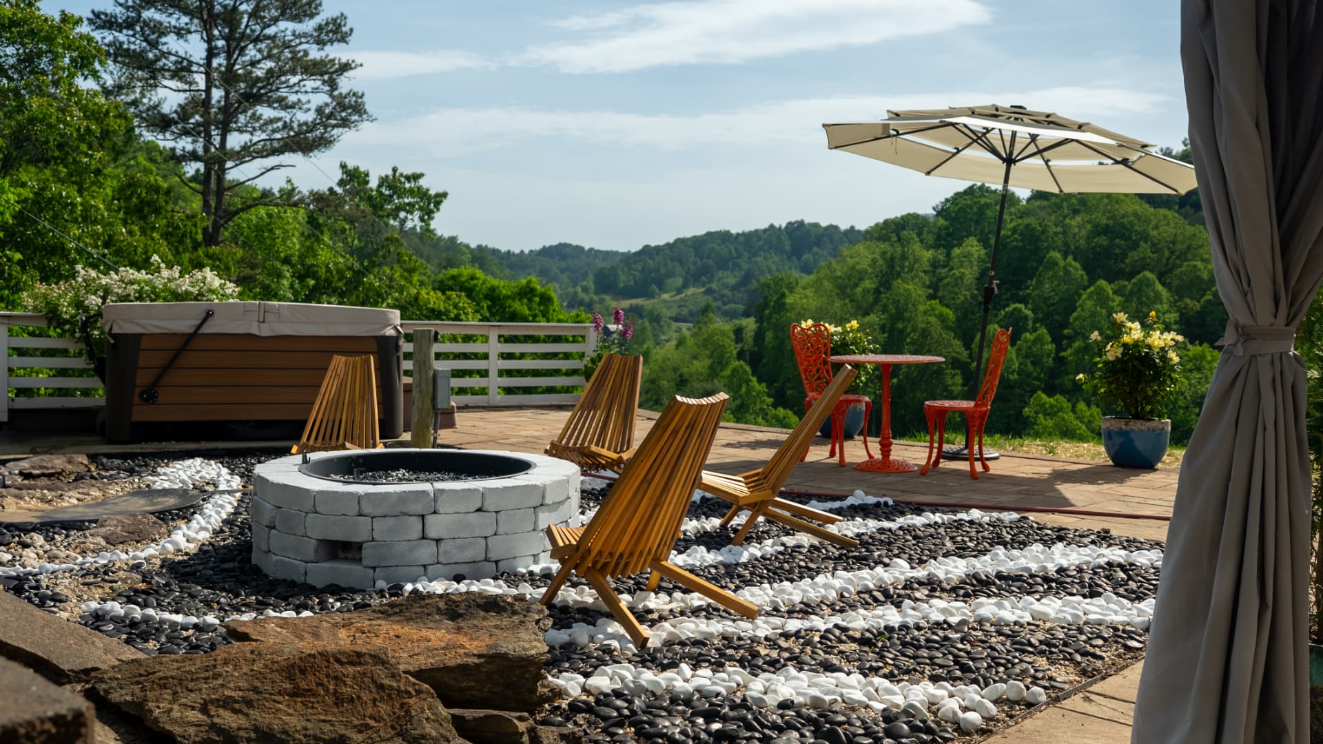 Fire pit, hot tub, and valley view on the back patio at Munaya Maison