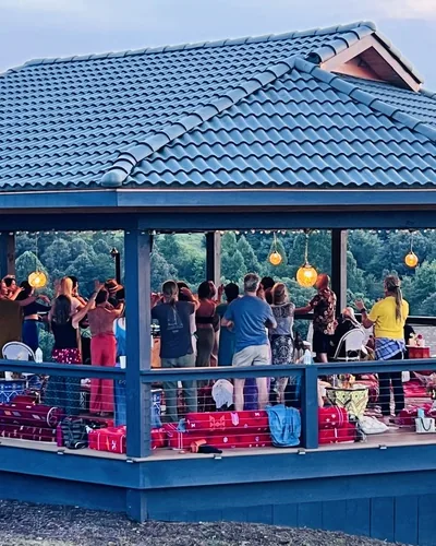 A child dancing with guests on the blue rug during Moroccan Night