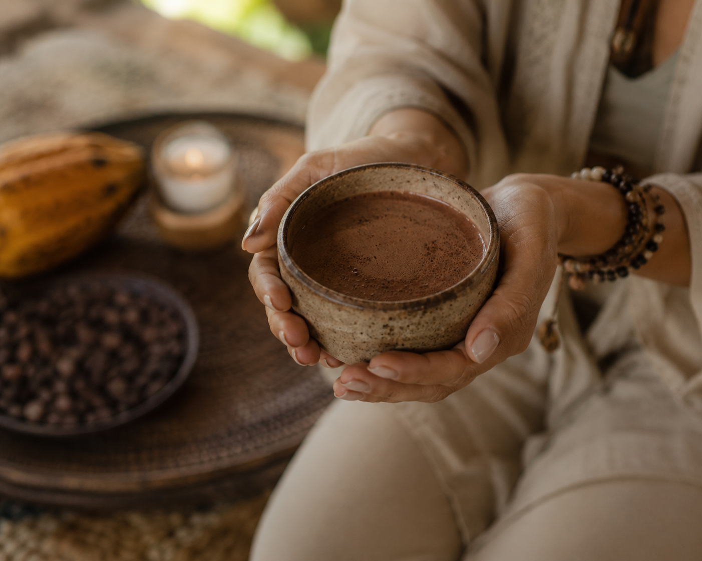 Hands holding a cup of cacao