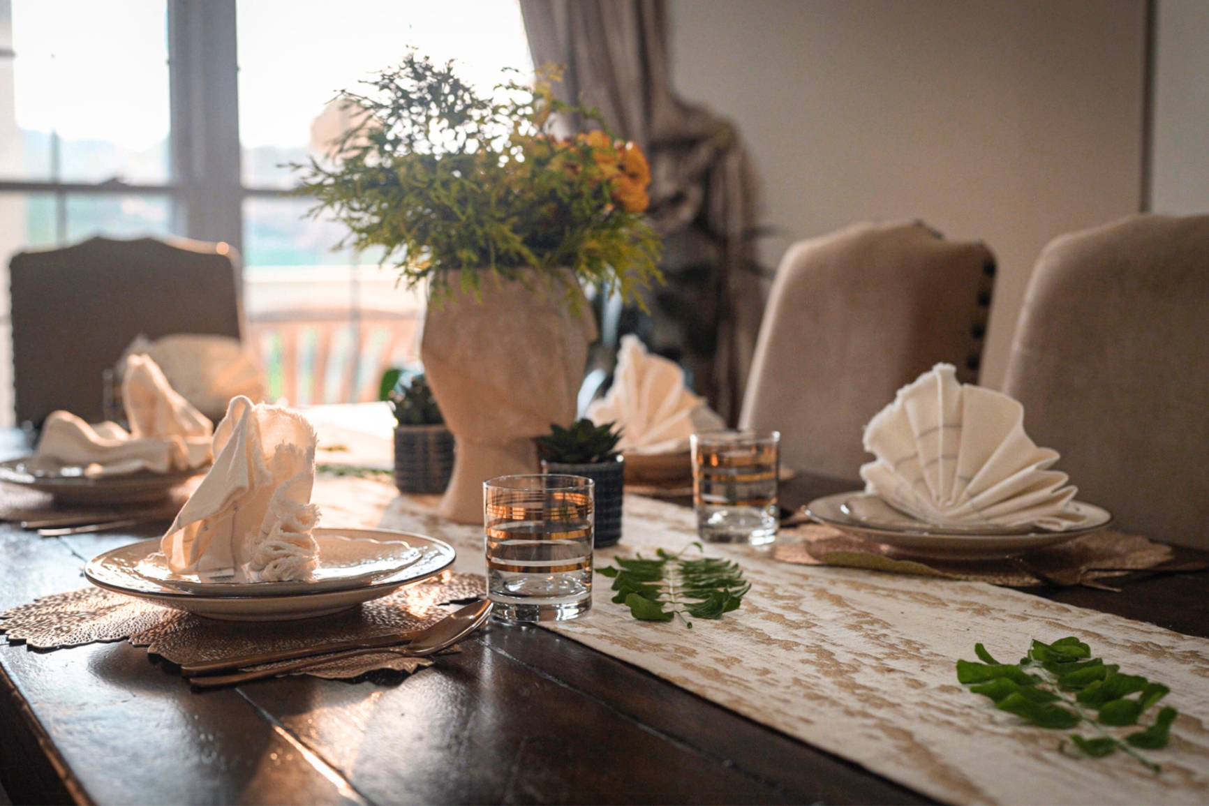 Dining table set for dinner at golden hour with pendant light
