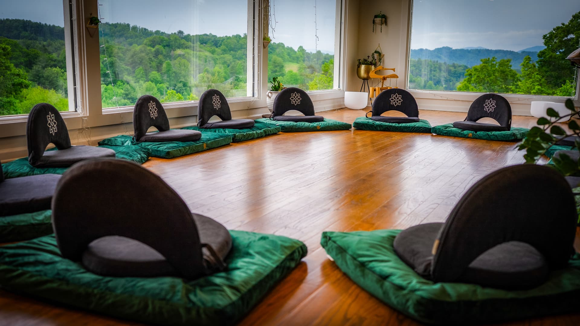 Meditation chairs and cushions set in a circle in the glass studio