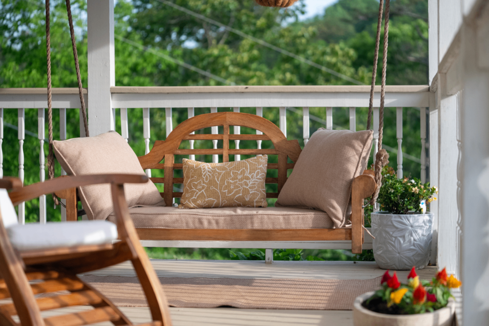 Porch swing with linen cushions on the wrap-around porch