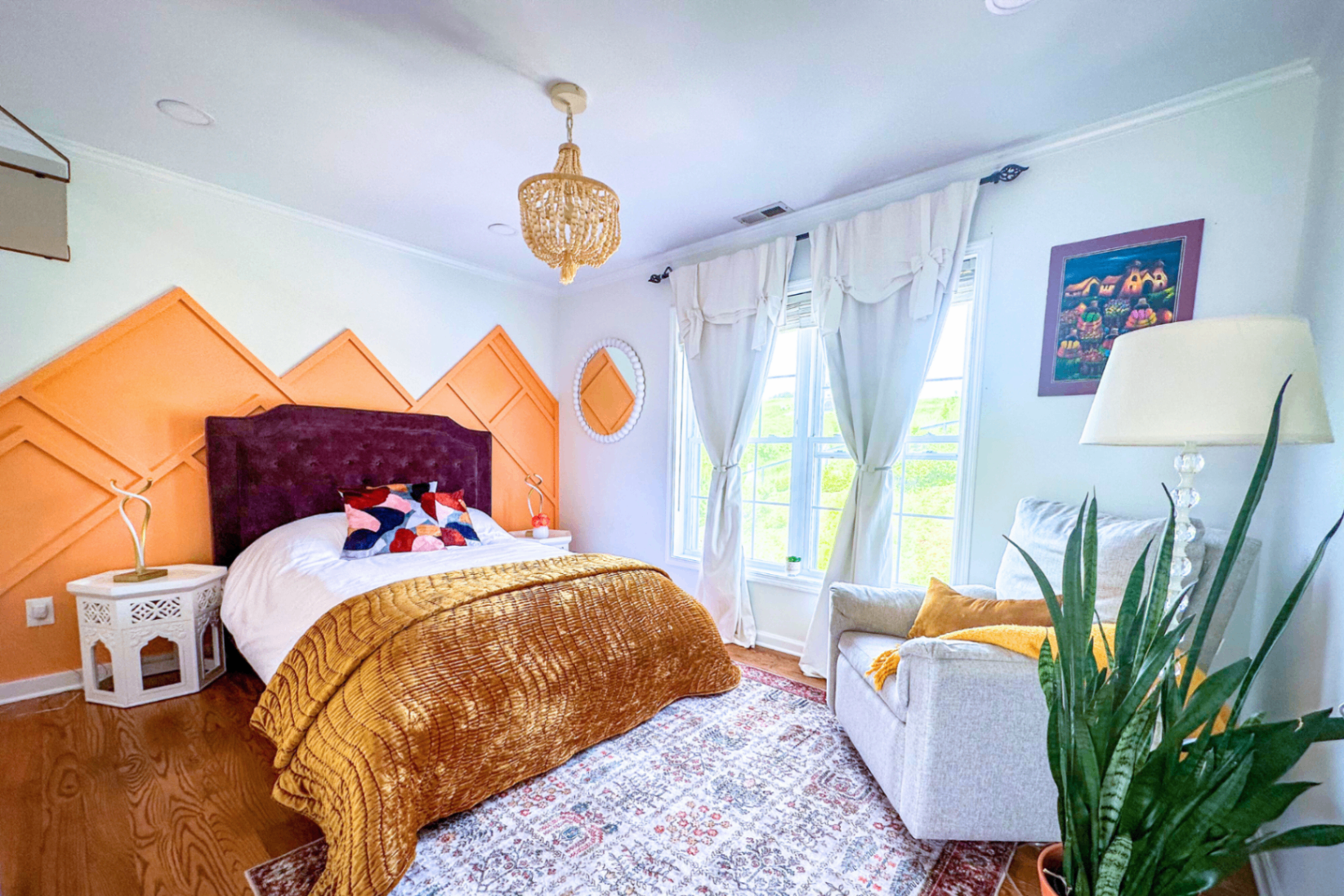 Sunrise Room with peach mountain wall and plum velvet headboard
