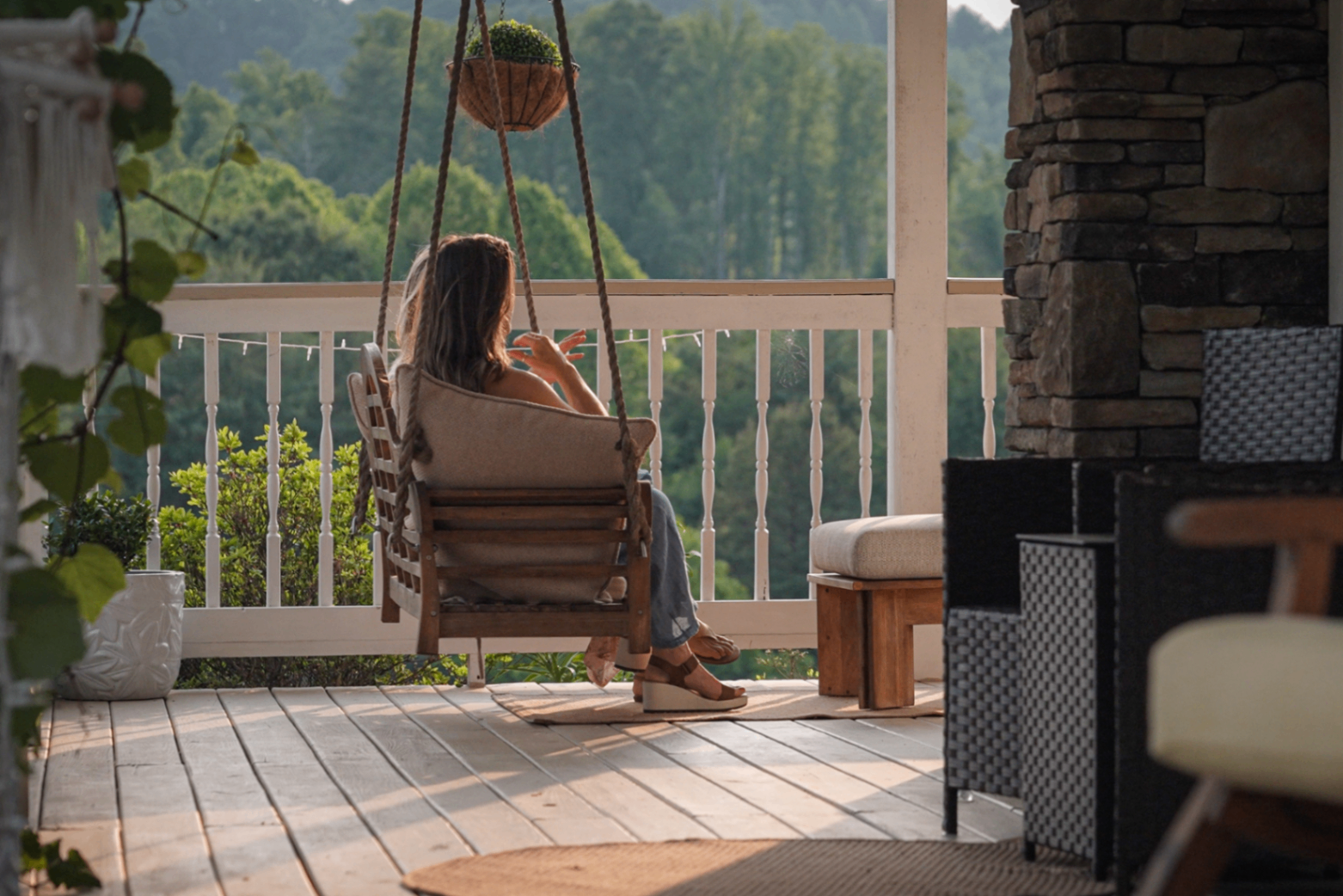 A guest on the porch swing looking out at the mountains
