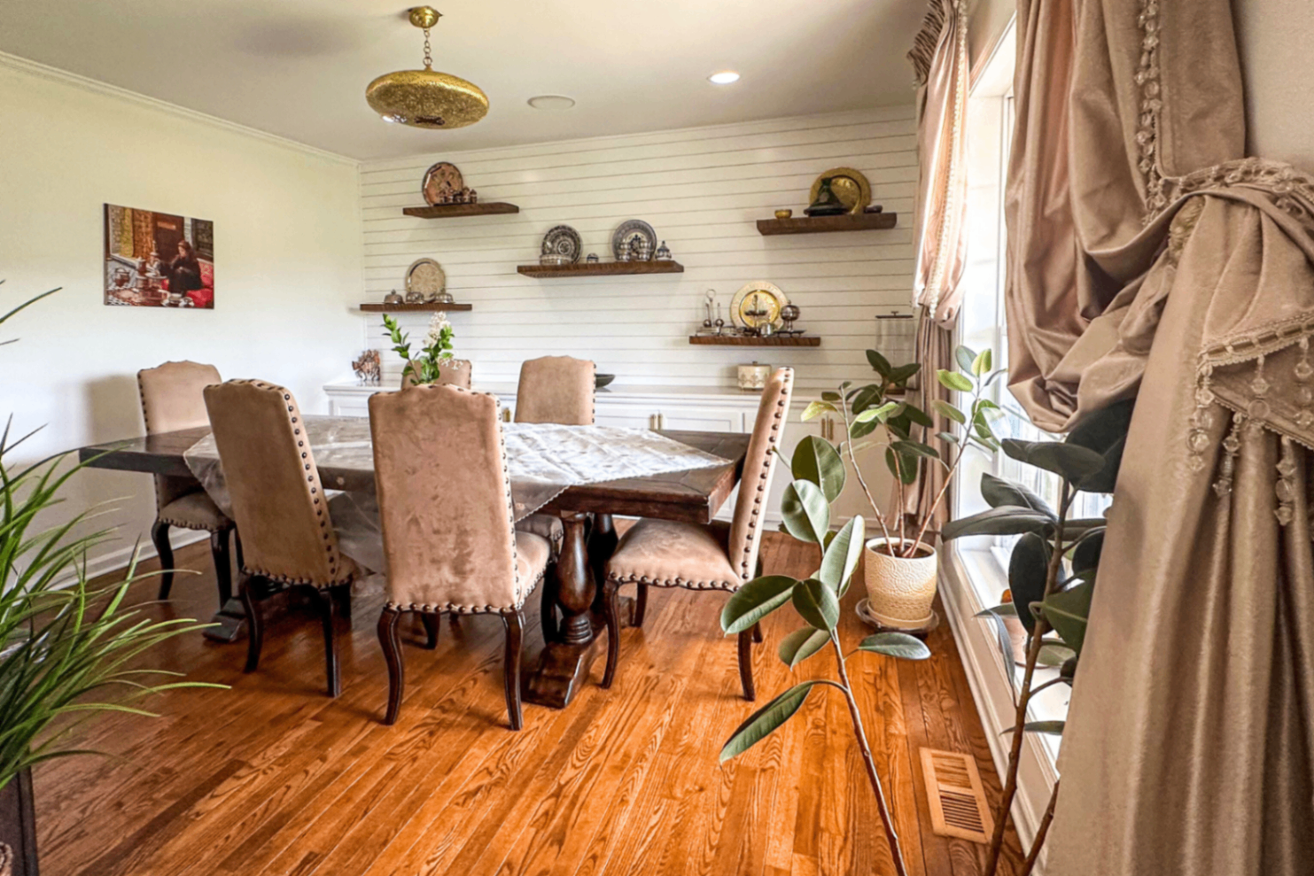 Dining room with long table and Moroccan brass pendant