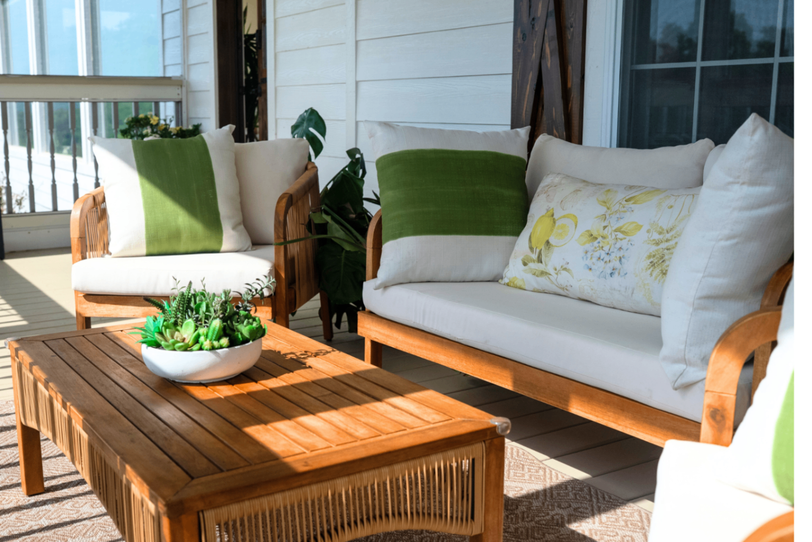 Porch loveseat with green pillows