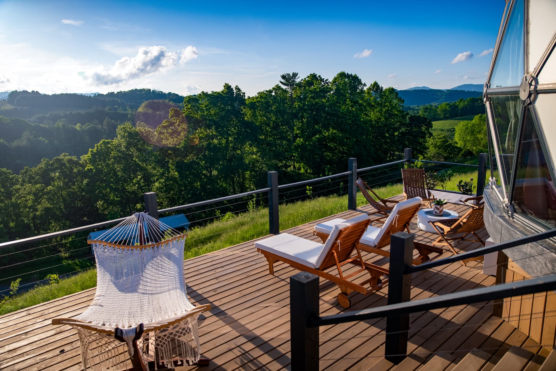 The private deck at Casablanca Dome with hammock, loungers and mountain view
