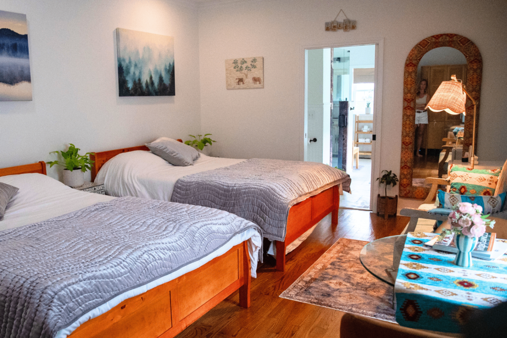 Guest room with two double beds and arched Moroccan mirror